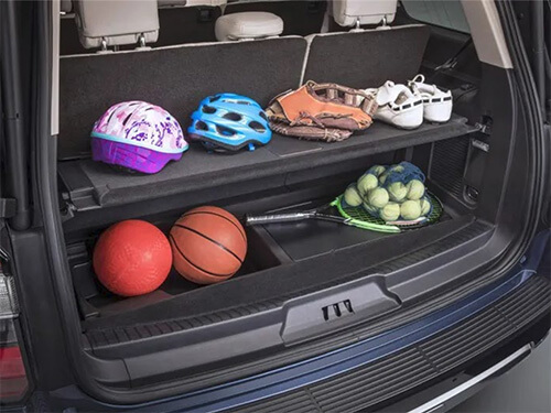 Sports equipment organized on the the multi-level cargo-management-system inside a Ford Expedition.
